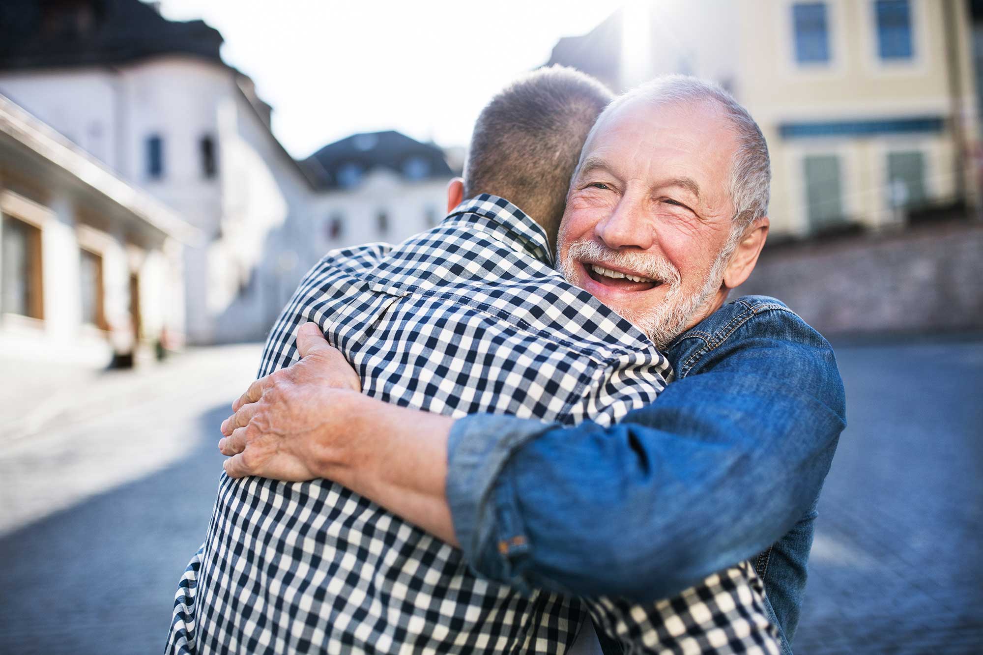 Men hugging and happy