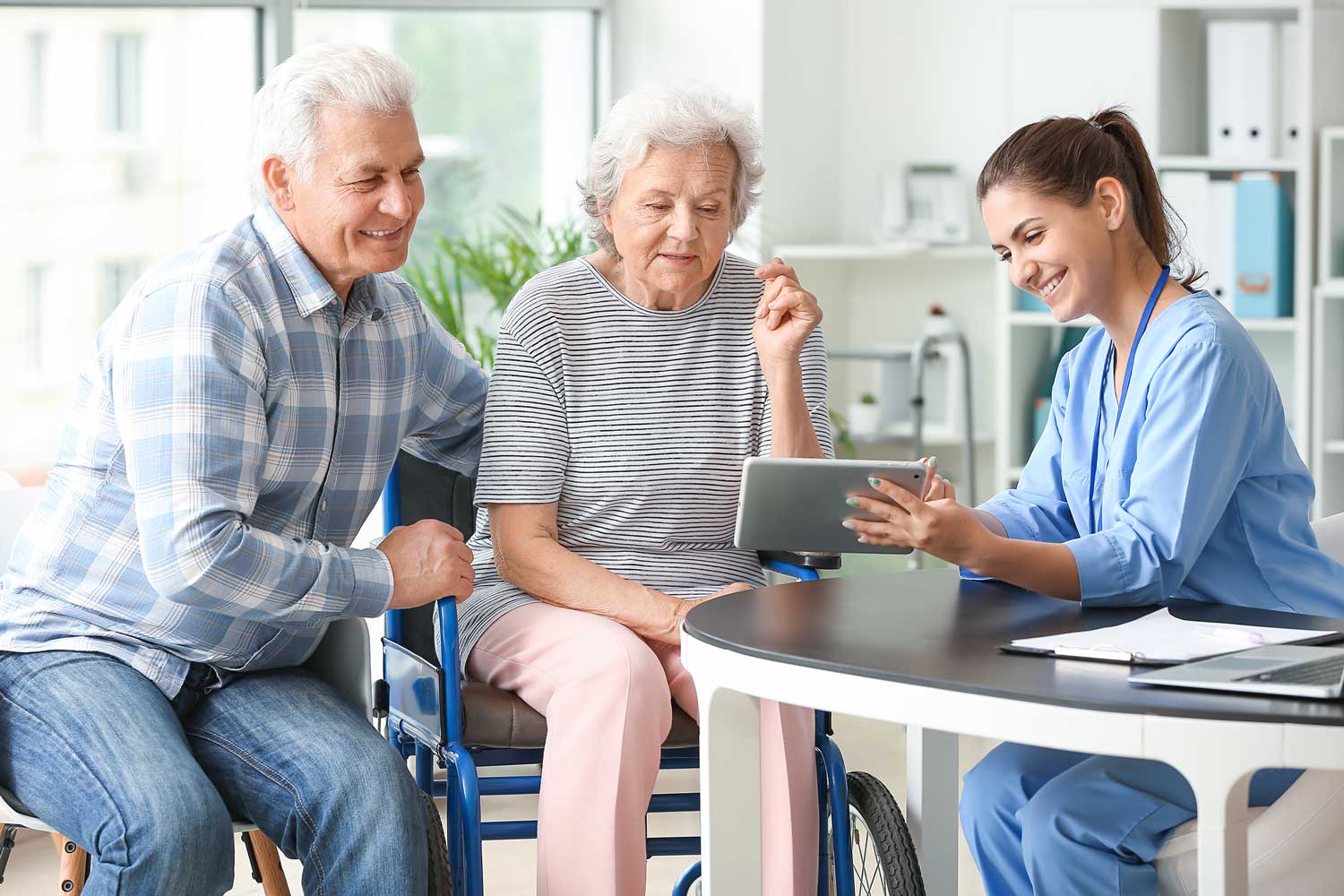 Nurse discussing care with senior couple