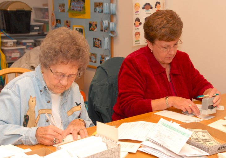 Volunteers writing thank you notes - Reflecting on 40 Years