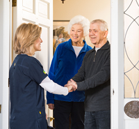 Hospice nurse greeting family at the door. Hospice Care