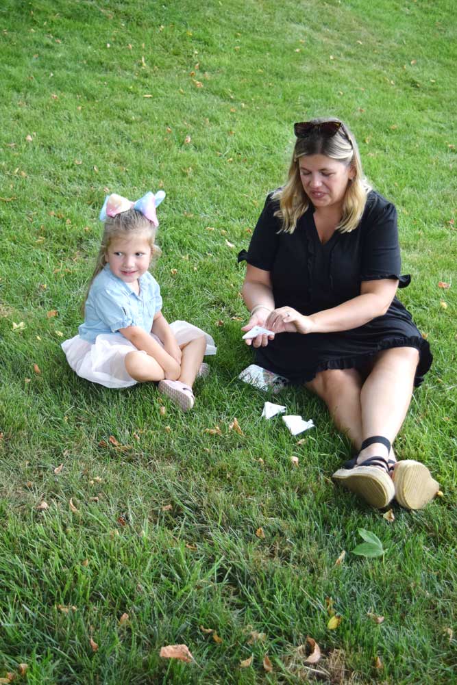 Butterfly Release guests sitting in the grass