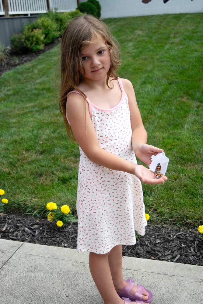 Little girl releasing a butterfly at the Newark Butterfly Release
