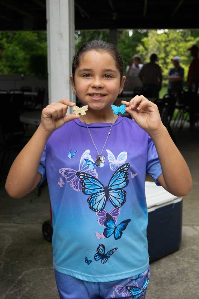 Little girl with butterfly trinkets at the Newark Butterfly Release