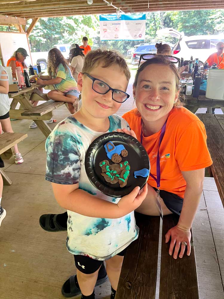 Camp Pathways North child with clay project