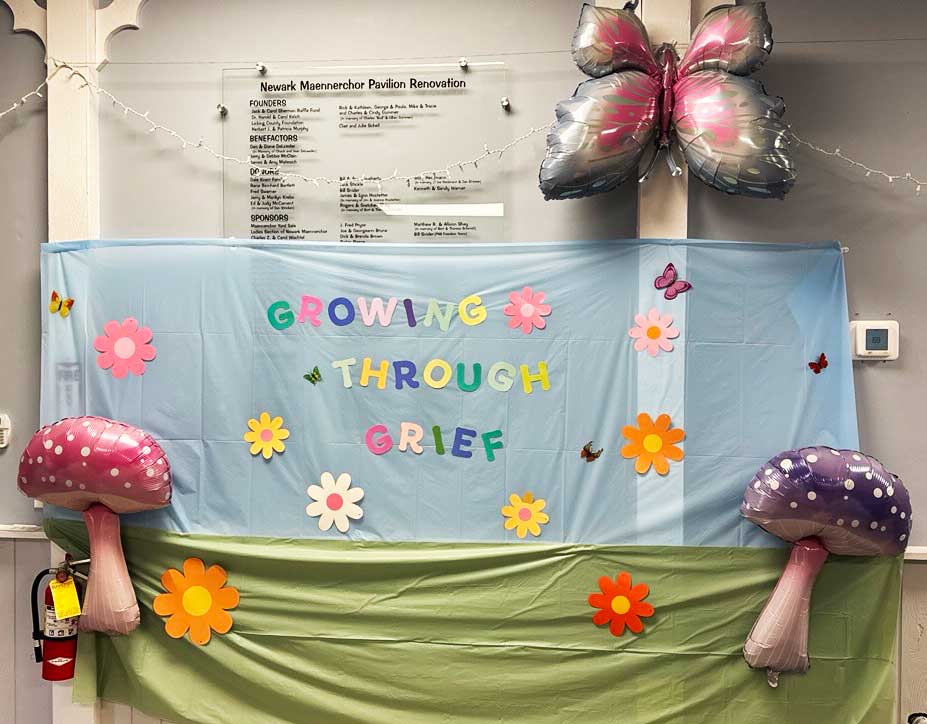 Camp Pathways Newark Growing Through Grief sign with flowers