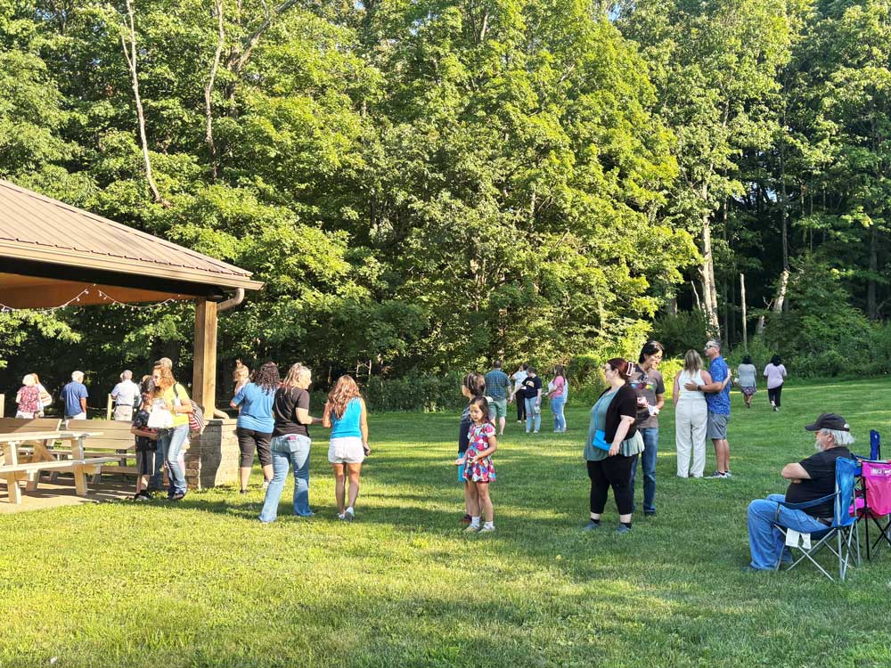 Guests in a field releasing butterflies at Ohio's Hospice Butterfly Release